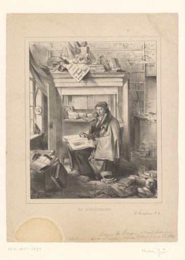 Man seated in a library with a book on his lap