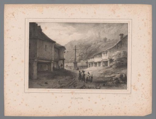 View of a street in a mountain village with a crucifix