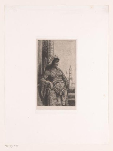 Woman on a balustrade with a mosque in the background