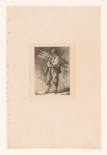 Man carrying a bundle of branches over his shoulder