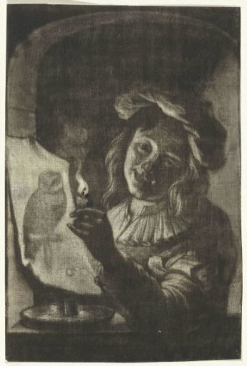 Boy with a print depicting an owl by candlelight