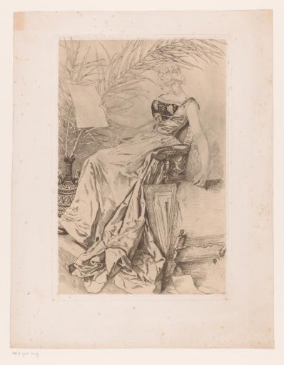Young woman in a chair leafing through an album