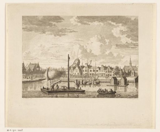 View of the towing of a ship's hull over the towpath at Zaandam