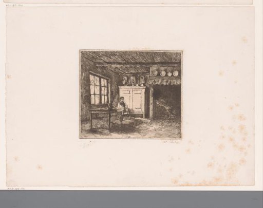 Young man seated in a room with a large fireplace