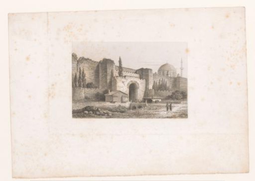 View of a city wall with gate and behind it a mosque