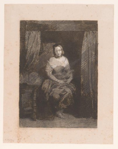 Young woman seated on a bed