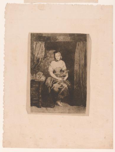 Young woman seated on a bed