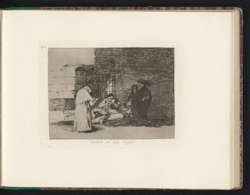 Woman with a bowl in a dark room with several persons