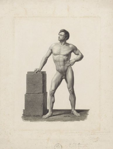 Standing male nude by a stone block