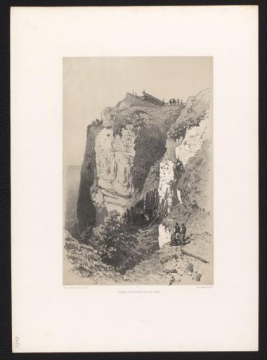 Steep rock wall by the sea with figures