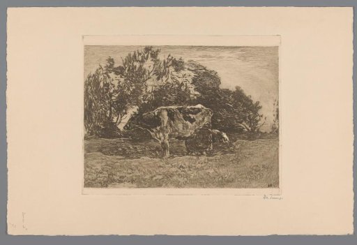 Meadow with farmer milking a cow