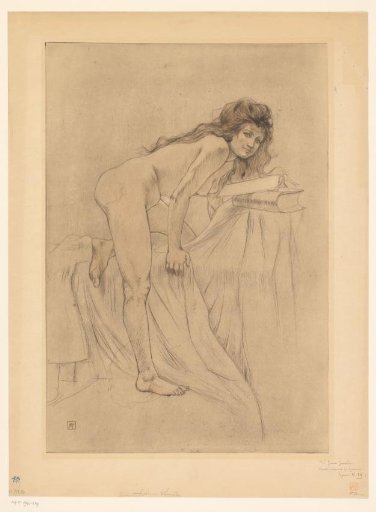 Nude woman leaning over books lying on a bed