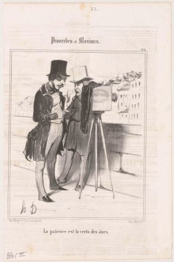 Photographer with camera looks at his pocket watch