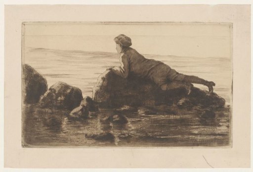 Boy Lying on Rocks on the Beach