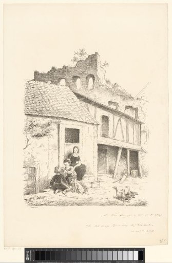Woman and children playing with puppies on the doorstep