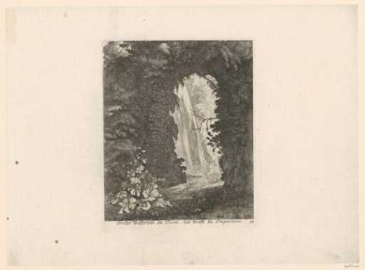 Large waterfall seen through a rock opening