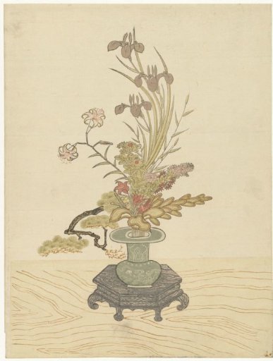 Ikebana flower arrangement in a green vase