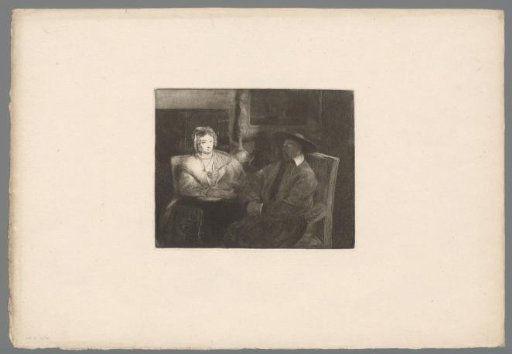 Man and woman seated in a room