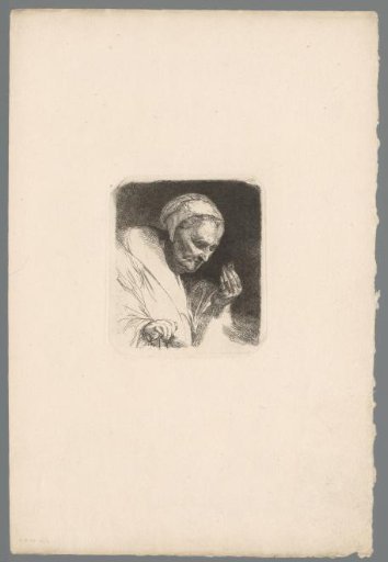 Old woman examining a ring