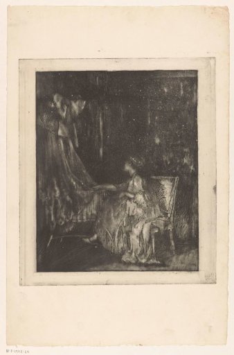 Woman sitting on a chair next to a cradle