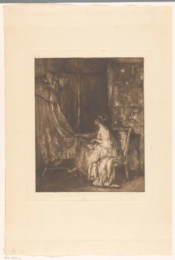 Woman sitting on a chair next to a cradle