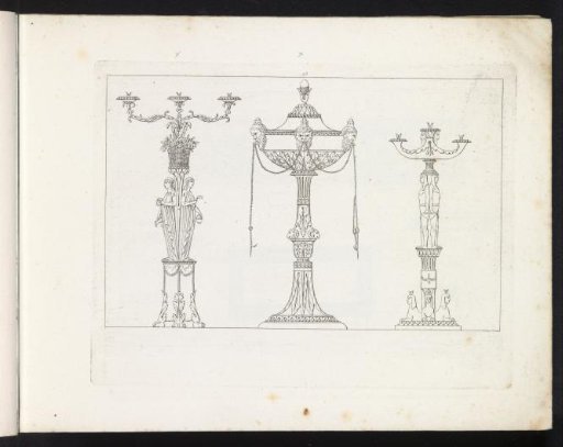 Two candlesticks and a vase on a high pedestal