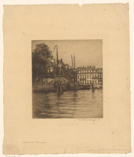 View of houses and sailing boats on the water in Amsterdam