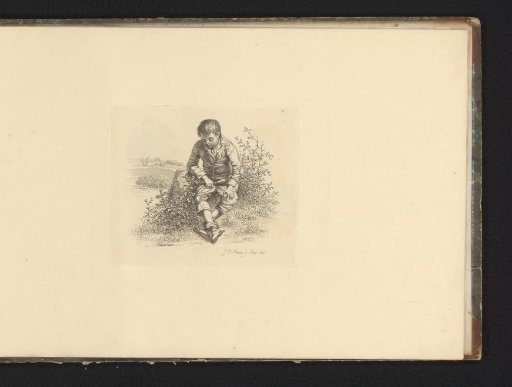 Boy sitting on a rock