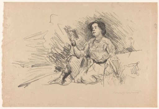 Reading girl sitting on the ground