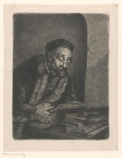 Man reading behind a table with a stack of books