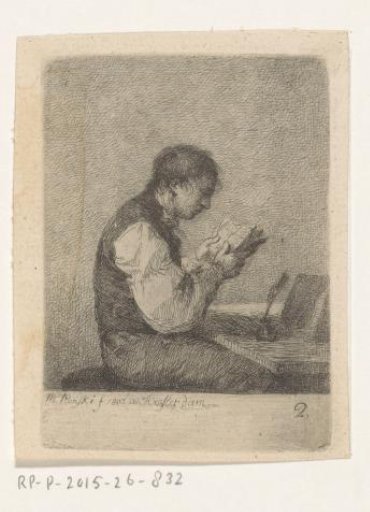 Young man reading behind a table