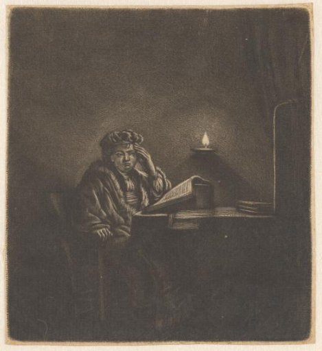 A student at a table by candlelight