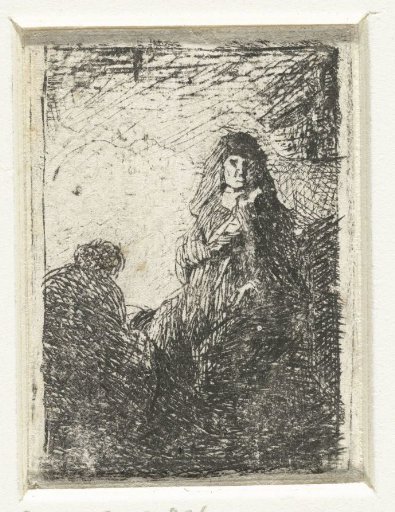 Standing woman and seated man
