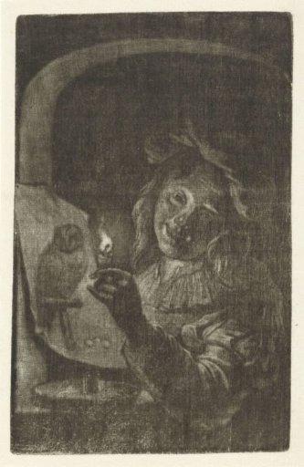Boy with a print depicting an owl by candlelight