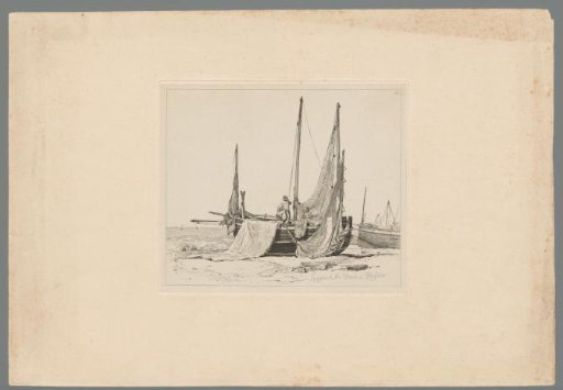 Man standing in a lugger with loose sails on the beach of Brighton