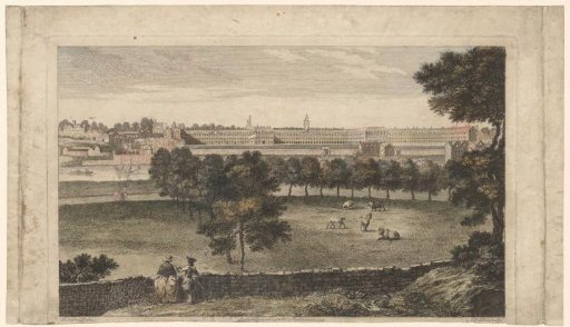 View of meadow and buildings on the other side of a river