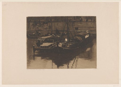 Moored barges at the Damrak in Amsterdam
