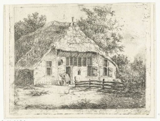 Woman bent over a basket in front of a house in Staphorst