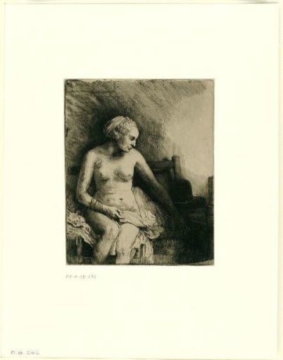Woman bathing with a hat beside her