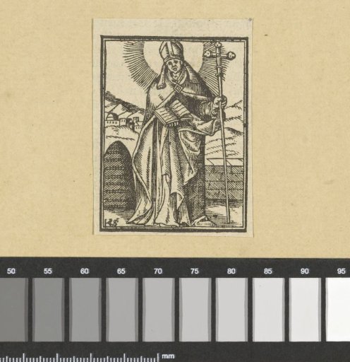 Saint by a wall in a mountain landscape