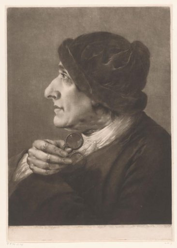 Man with a pair of spectacles in his hand