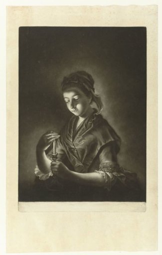 Young woman holding her hand before a candle