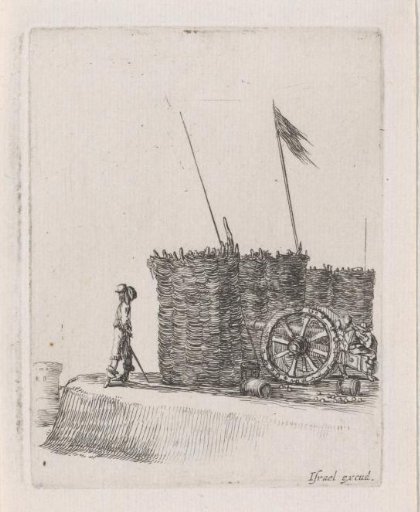 A soldier on watch and a cannon behind a reed screen