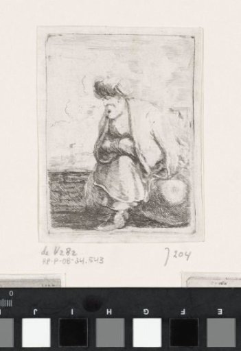 Old Turkish man with beard and turban sitting on a stone