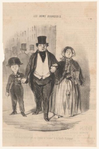 Couple walking with their son down the street