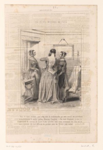 Seamstress helping a woman with the fitting of a dress