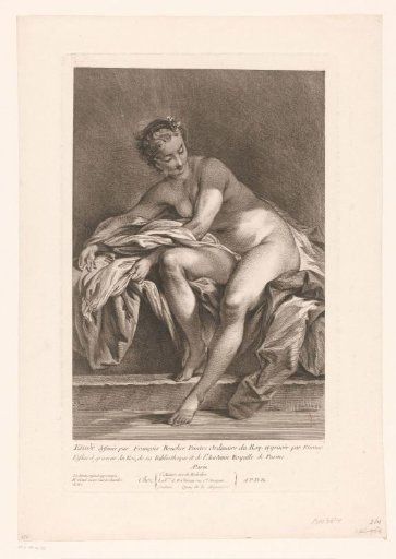 Nude woman with her foot in a bath