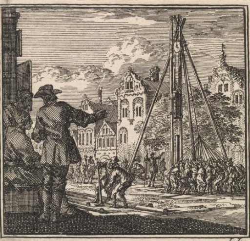 Several men watching a pile being driven into the ground with a pile driver