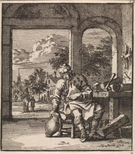 A man sitting next to a workbench with a jug