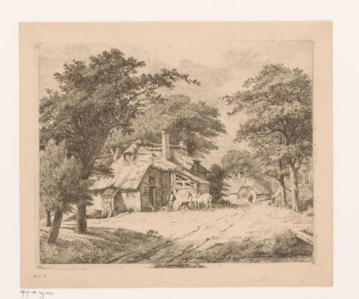 White horse at a manger in front of a farm